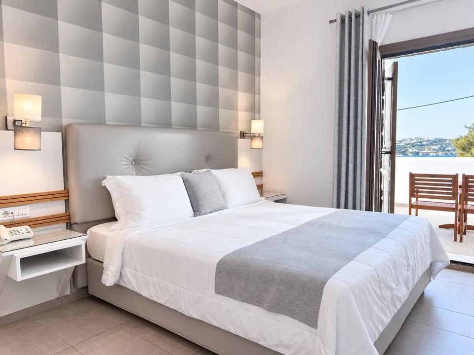 Double bedroom in Suite 103 with doors to the veranda